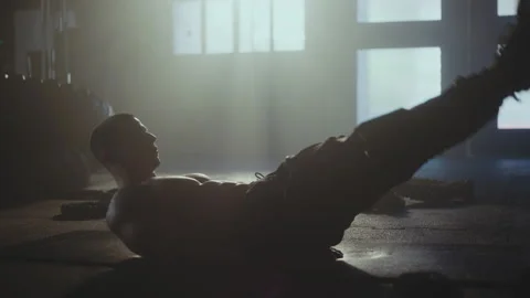 Young man doing abs exercise Stock Footage 236180298