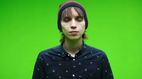 Young man doing agree symbol by nodding his head against a removable chroma key Stock Footage 155585265