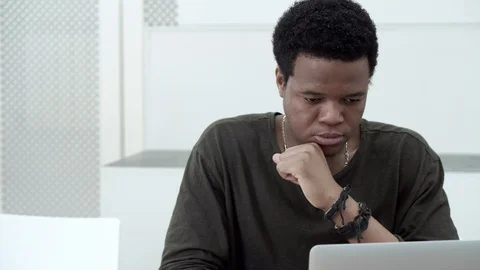 Young man doing assignment on laptop Stock Footage 91725110