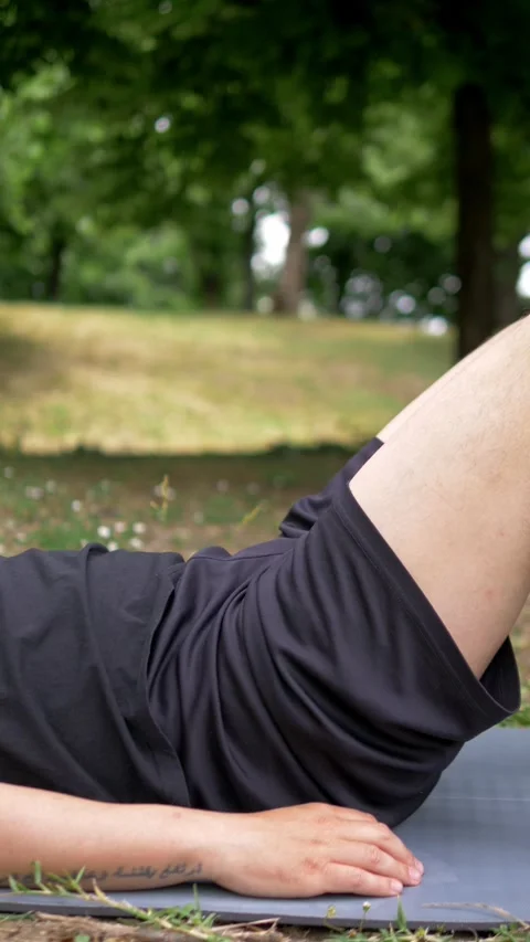 Young Man Doing Back Bridge Exercise During Amateur Outdoor Park Workout Stock Footage 335696662