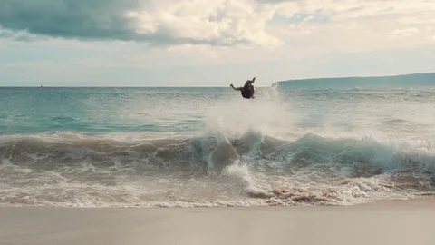 Young man doing back flip on a skim board Stock-Footage 99597914