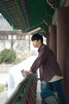 A young man doing a backpacking trip in a Korean traditional house. Stock Photos