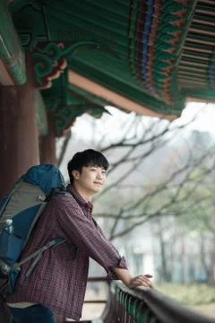 A young man doing a backpacking trip in a Korean traditional house. Stock Photos