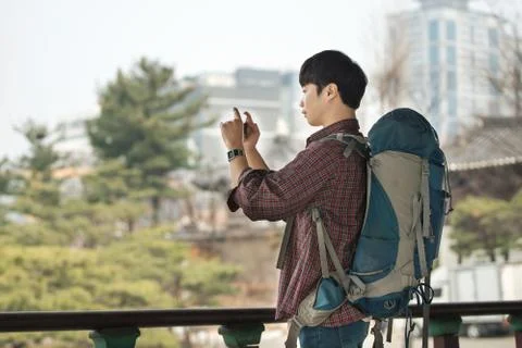 A young man doing a backpacking trip in a Korean traditional house. I'm takin Stock Photos