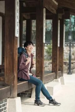 A young man doing a backpacking trip in a Korean traditional house. Stock Photos
