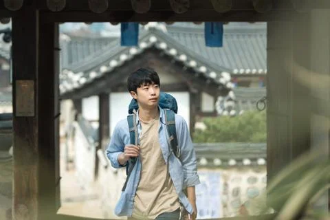 A young man doing a backpacking trip in a Korean traditional house. Stock-Fotos