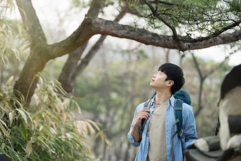 A young man doing a backpacking trip in a Korean traditional house. Stock Photos