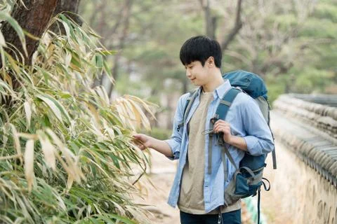 A young man doing a backpacking trip in a Korean traditional house. Stock Photos