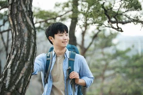 A young man doing a backpacking trip in a Korean traditional house. Stock Photos
