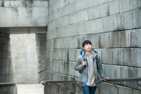 A young man doing a backpacking trip in a Korean traditional house. Stock Photos