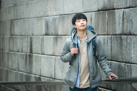 A young man doing a backpacking trip in a Korean traditional house. Stock Photos