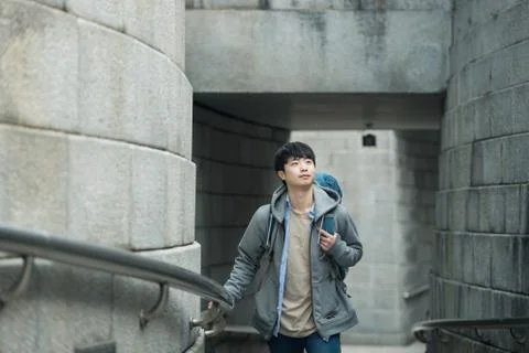A young man doing a backpacking trip in a Korean traditional house. Stock Photos