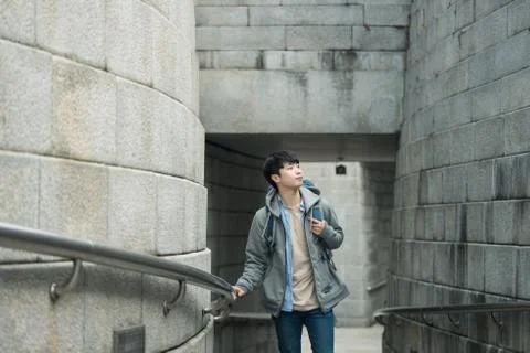 A young man doing a backpacking trip in a Korean traditional house. Stock Photos