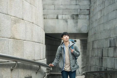 A young man doing a backpacking trip in a Korean traditional house. Stock Photos