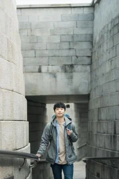 A young man doing a backpacking trip in a Korean traditional house. Stock Photos
