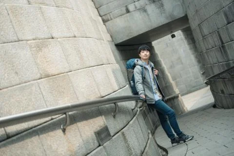 A young man doing a backpacking trip in a Korean traditional house. Stock Photos