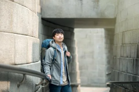 A young man doing a backpacking trip in a Korean traditional house. Stock Photos