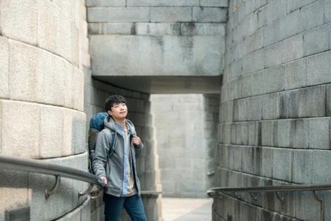 A young man doing a backpacking trip in a Korean traditional house. Stock Photos