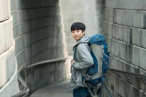 A young man doing a backpacking trip in a Korean traditional house. Stock Photos