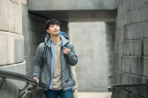 A young man doing a backpacking trip in a Korean traditional house. Stock Photos