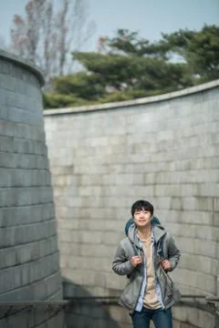 A young man doing a backpacking trip in a Korean traditional house. Stock Photos