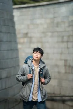 A young man doing a backpacking trip in a Korean traditional house. Stock Photos