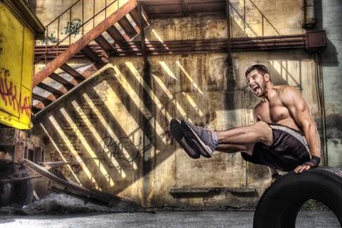 Young man doing balance exercise on street background Stock Photos