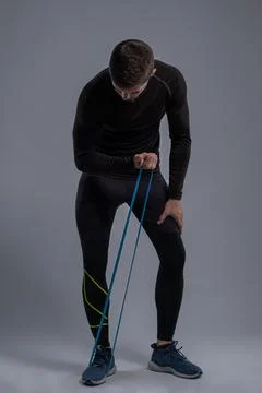 Young man doing biceps workout with resistance band Foto stock