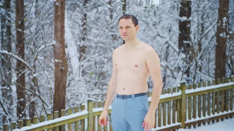 Young man doing cold hardening conditioning with snow in winter Stock Footage 126661514