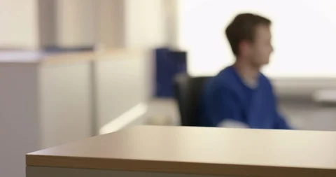Young man doing desk work in warm lighting Video stock 105417534