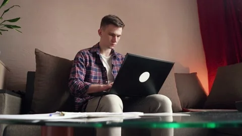 Young man is doing distance learning at home using a computer. Stock Footage 207782366