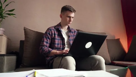 Young man is doing distance learning at home using a computer. Stock Footage 209306630