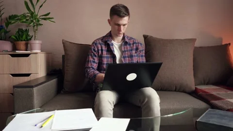 Young man is doing distance learning at home using a computer. coronavirus Stock Footage 211812775