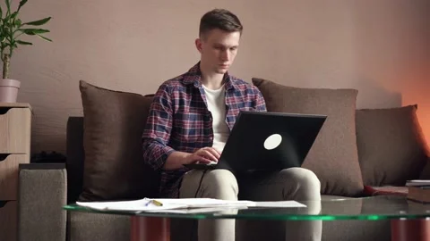 Young man is doing distance learning at home using a computer. Stock Footage 212611120