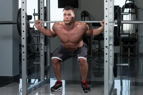 Young Man Doing Exercise Barbell Squat Stock Photos