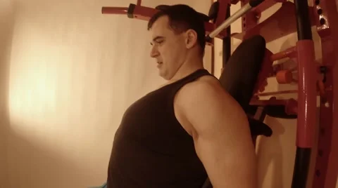 Young Man Doing Exercise With Dumbbells in the Wall Bars in the Room Stock Footage 62475596