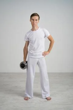 Young Man doing Exercise with Dumbbells Foto stock