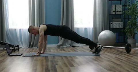 Young man doing exercise indoors at home, a body workout. Sport and fitness.  Stock Footage 152833497