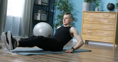 Young man doing exercise indoors at home, a body workout. Sport and fitness.  Stock Footage 152833970
