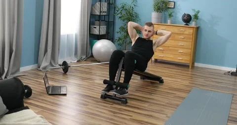 Young man doing exercise indoors at home, a body workout. Sport and fitness. Stock Footage 152834269