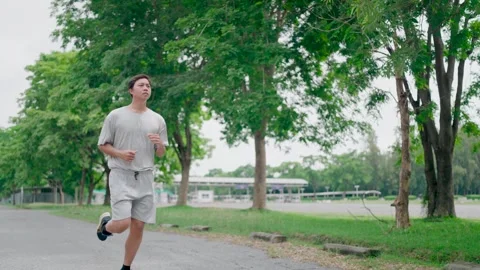 Young man doing exercise in the morning, sportsman running exercise outdoors in  Stock Footage 283187055