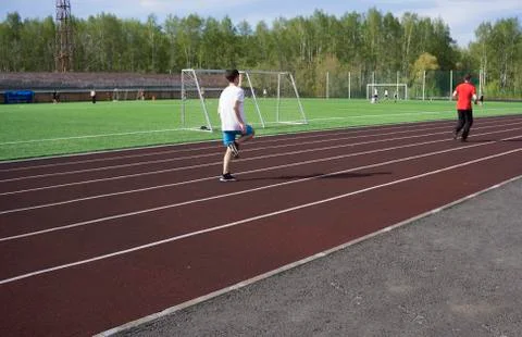 Young man in doing exercise. at the stadium Stock Photos