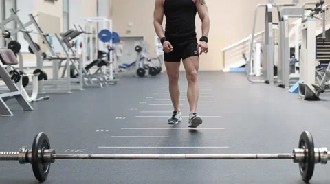 Young man doing exercises in a gym Stock Footage 62561518