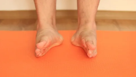 Young man doing exercises for his feet and toes Stock Footage 114388284