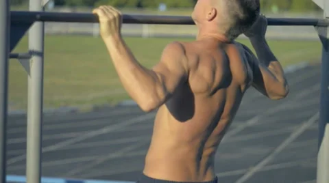 Young man is doing exercises on a horizontal bar Stock Footage 67483918