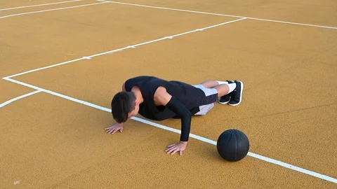 Young man doing exercises on outdoor court. Stock Footage 115593856