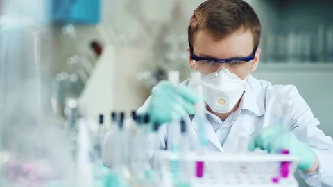 A young man doing an experiment in a chemical laboratory Stock-Footage 85328779