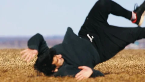 Young man doing a flip. Falling on the ground and stands up Stock Footage 106859442