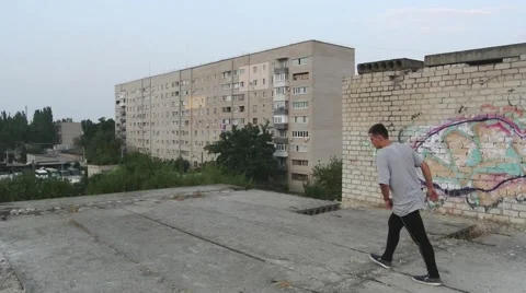 Young man Doing flips and Jumping on the roof.  Stock Footage 67316019