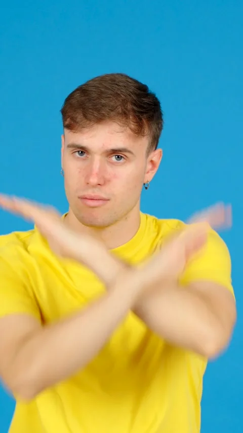 Young man doing forbidden gesture Stock Footage 254458272